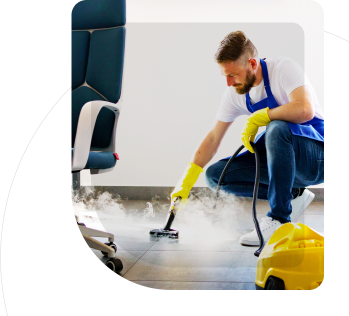 Men cleaning the fool with the vacuum cleaner and smoke in floor